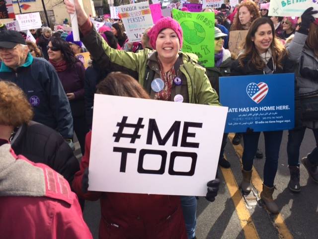 Peggy Farrelly at a rally with a #MeToo sign