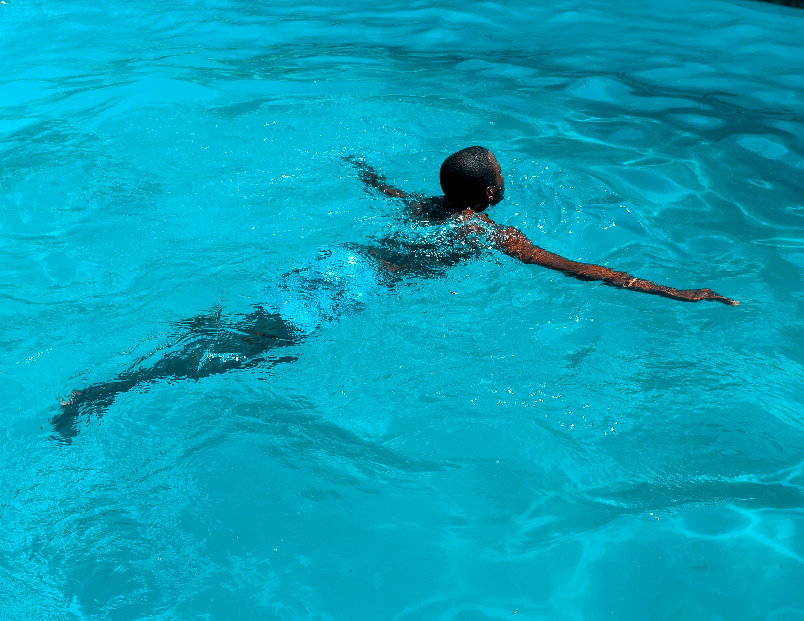 a black person swimming in a pool