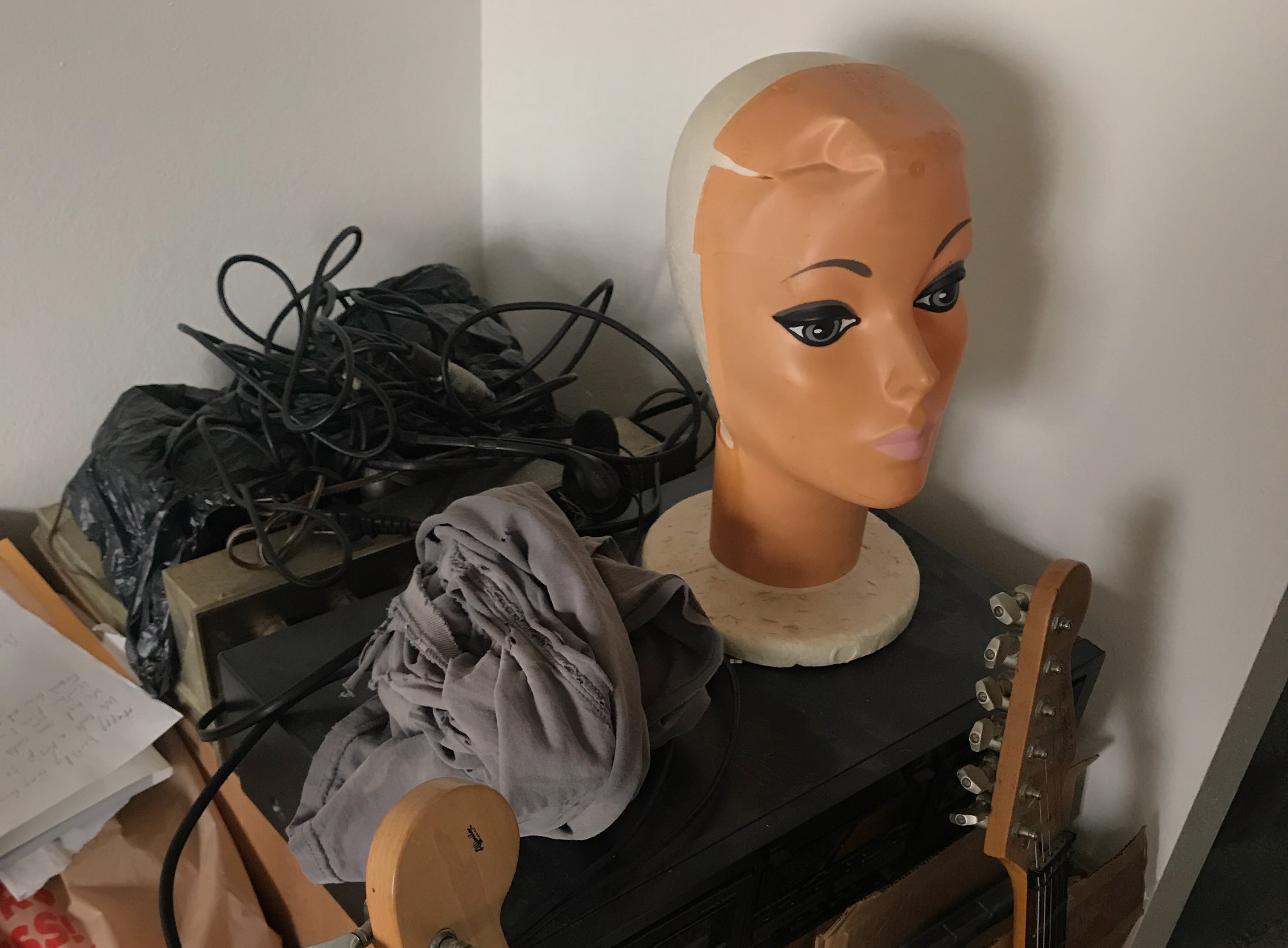 mannequin head, tangled guitar chords, guitars, paper, shirt