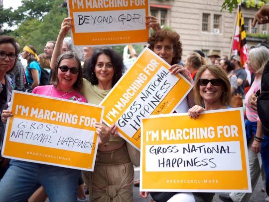 Ginny Sassaman and friends promote Gross National Happiness at a climate march