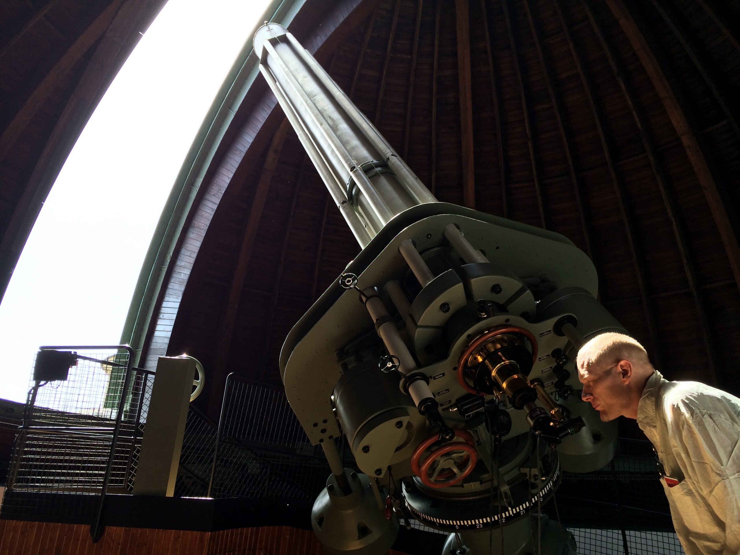 JD Stillwater looking into a telescope in Germany